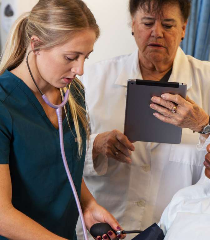 nurses checking patient blood pressure